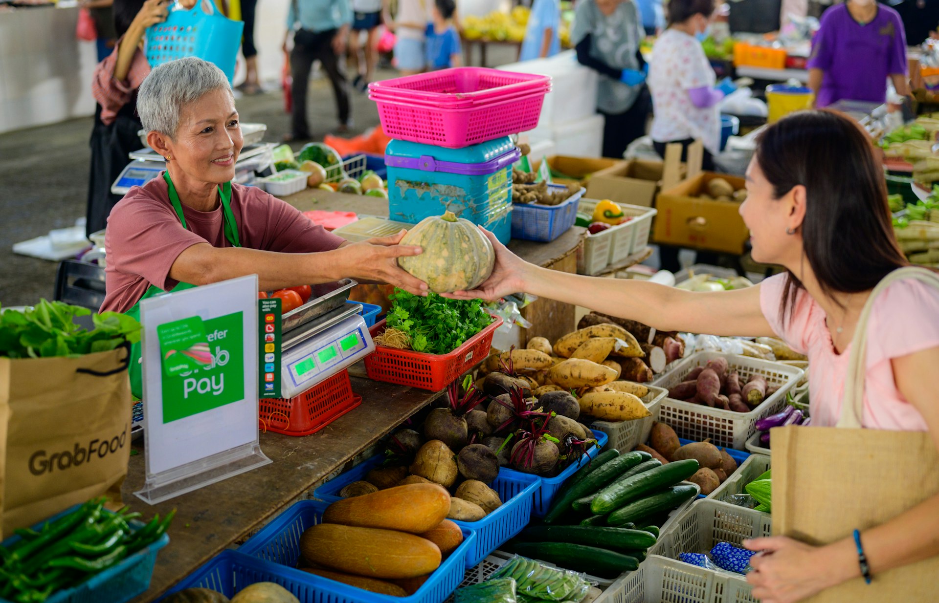 a woman handing a piece of food to another woman